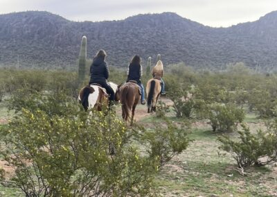 3 women riders headed into the desert